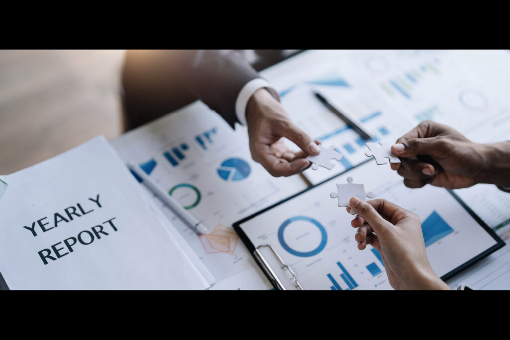 Professionals connecting puzzle pieces over a yearly report