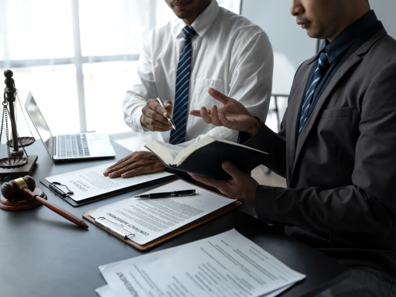 Serious Businessmen Reviewing Contracts in Office