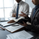 Serious Businessmen Reviewing Contracts in Office